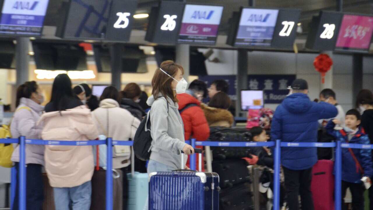 A woman wears a mask at Shanghai Pudong International Airport on Jan. 26, 2020, amid the spread of pneumonia caused by a new coronavirus in the central Chinese city of Wuhan. (Kyodo via AP Images) ==Kyodo