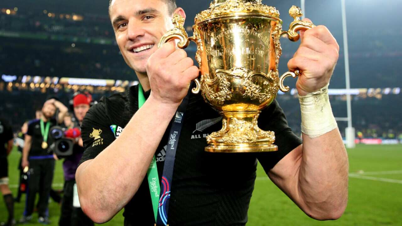 New Zealand's Dan Carter celebrates with the Webb Ellis Cup