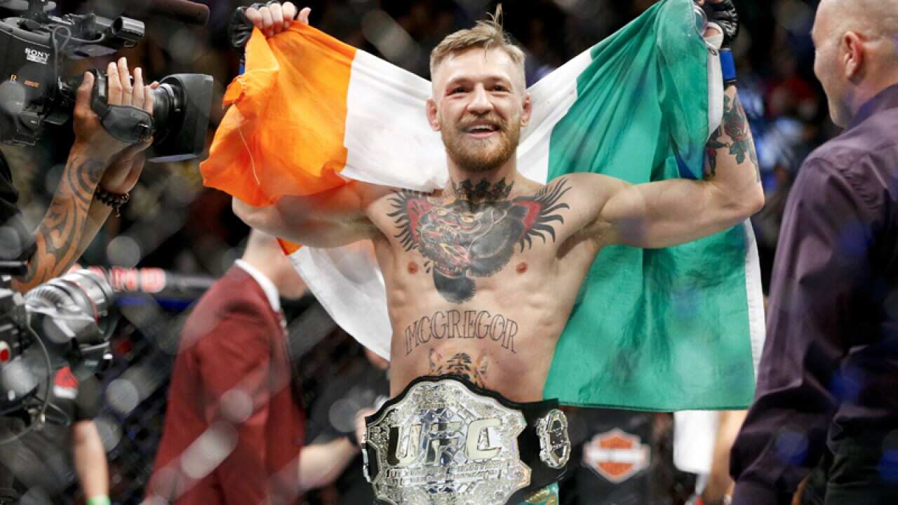 Conor McGregor reacts after defeating Jose Aldo