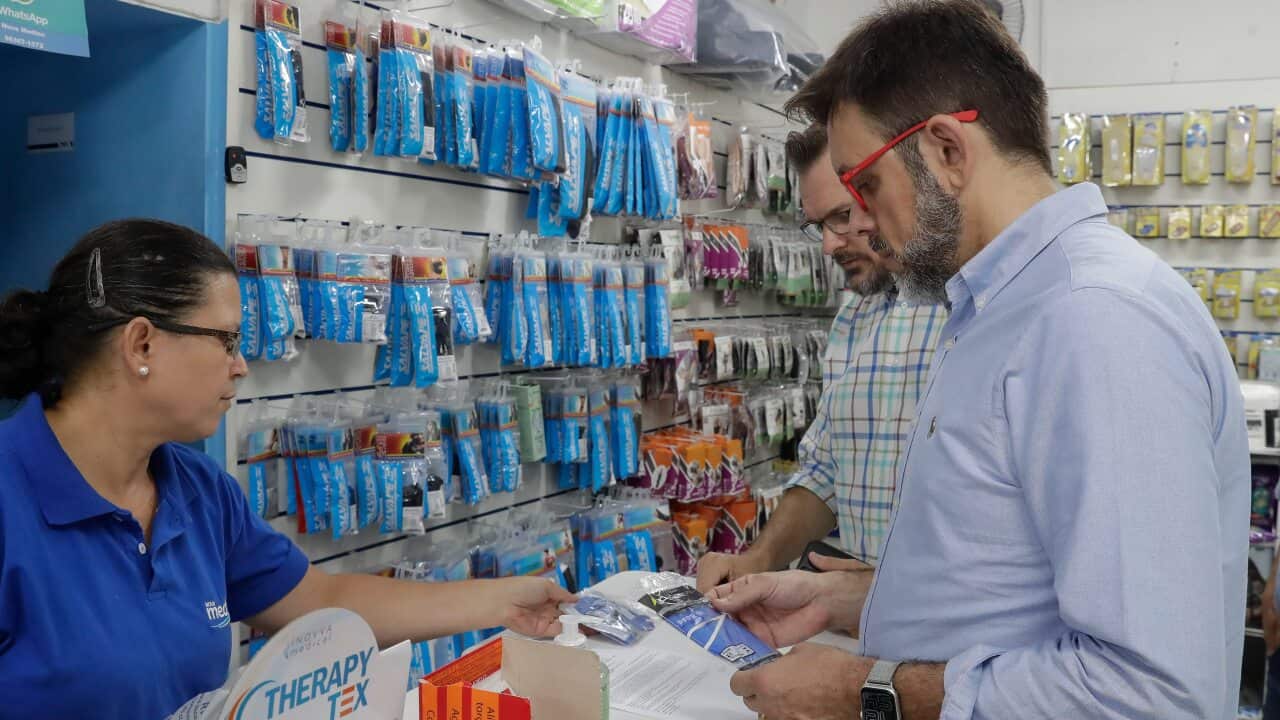 Customers buy masks at a medical supply store in Sao Paulo after Brazil's government confirmed the country's first confirmed case of the new coronavirus.