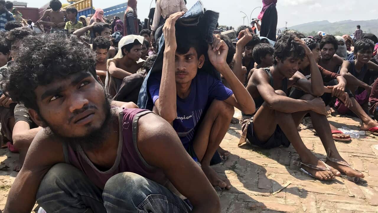 Rohingya refugees gather after being rescued in Teknaf near Cox's Bazar, Bangladesh