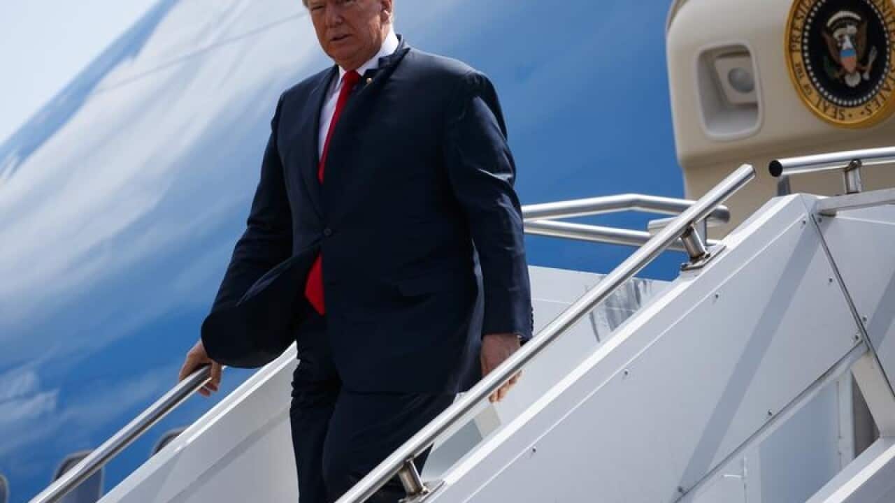 President Donald Trump steps off Air Force One in Houston