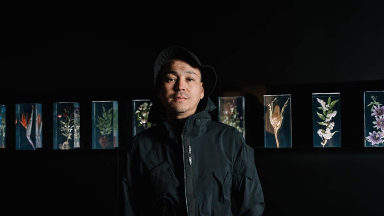 Portrait of Azuma Makoto with his works Drop time 2023 and A Chaotic Garden 2023 on display in NGV Triennial until 7 April 2024 at NGV International, Melbourne. Photo: Phoebe Powell