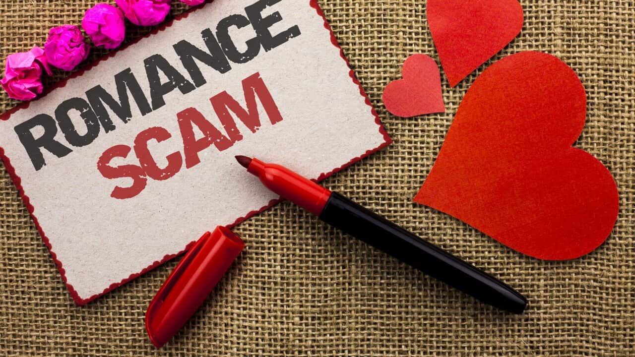 Word writing text Romance Scam. Business concept for Dating Cheat Love Embarrassed Fraud Cyber Couple Affair written on Cardboard Piece on the jute background Marker and Hearts next to it.