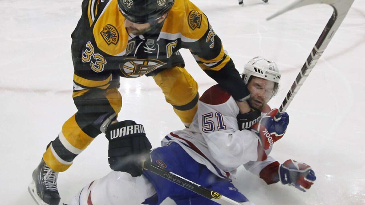 Boston Bruins' Zdeno Chara with Montreal Canadiens' David Desharnais