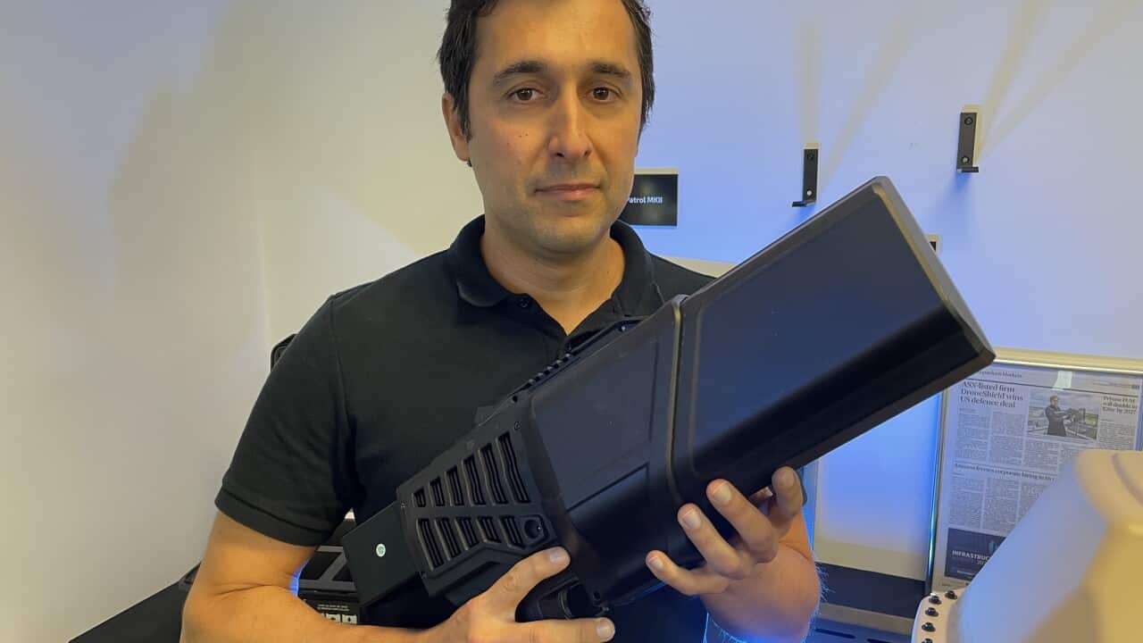 DroneShield CEO Oleg Vornik holds a counter drone device (SBS - Sandra Fulloon).jpg