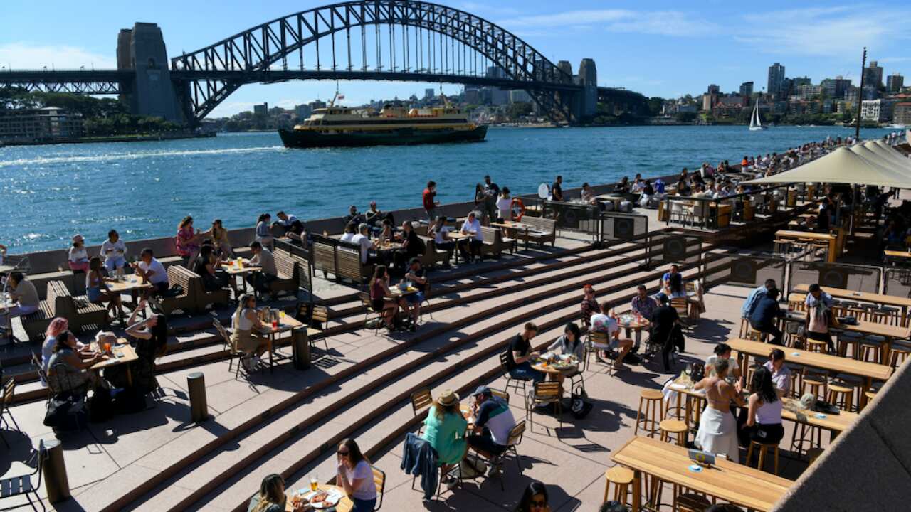 Members of the public are seen at outdoor dinning areas at The Sydney Opera House, in Sydney, Sunday, October 17, 2021.