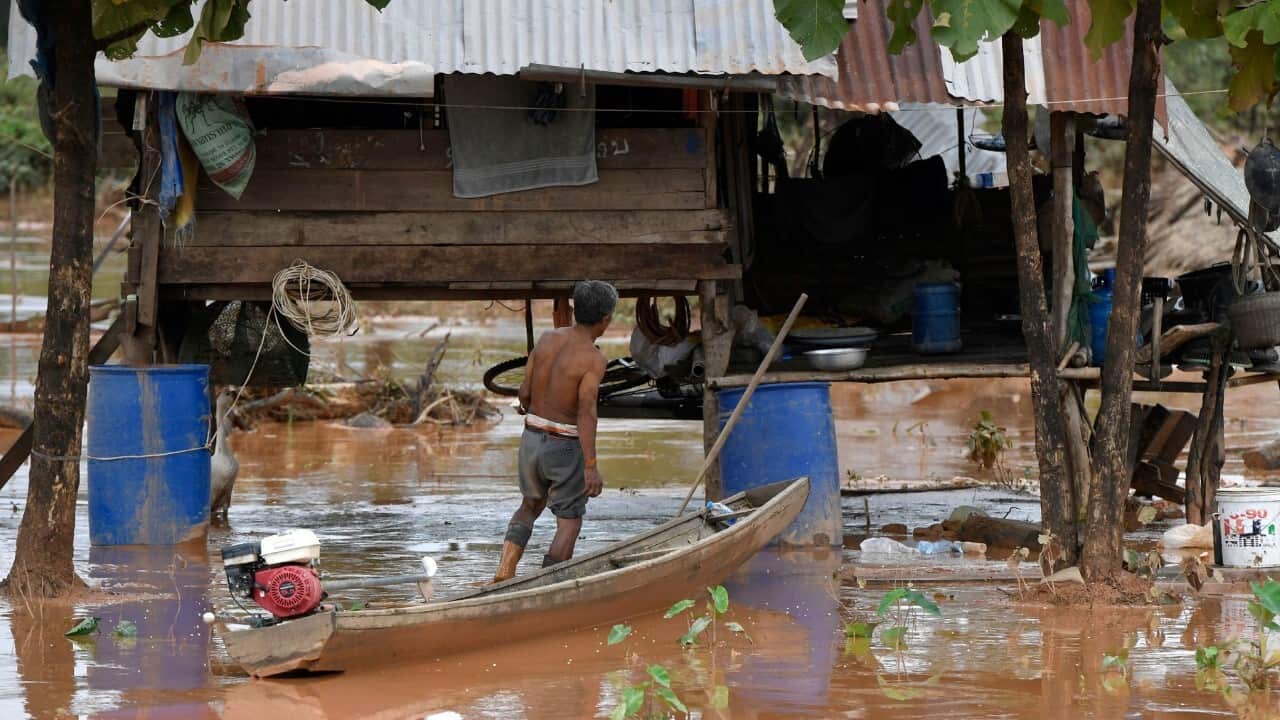 A Lao resident returning to his flooded home(NHAC NGUYEN - AFP via Getty Images)