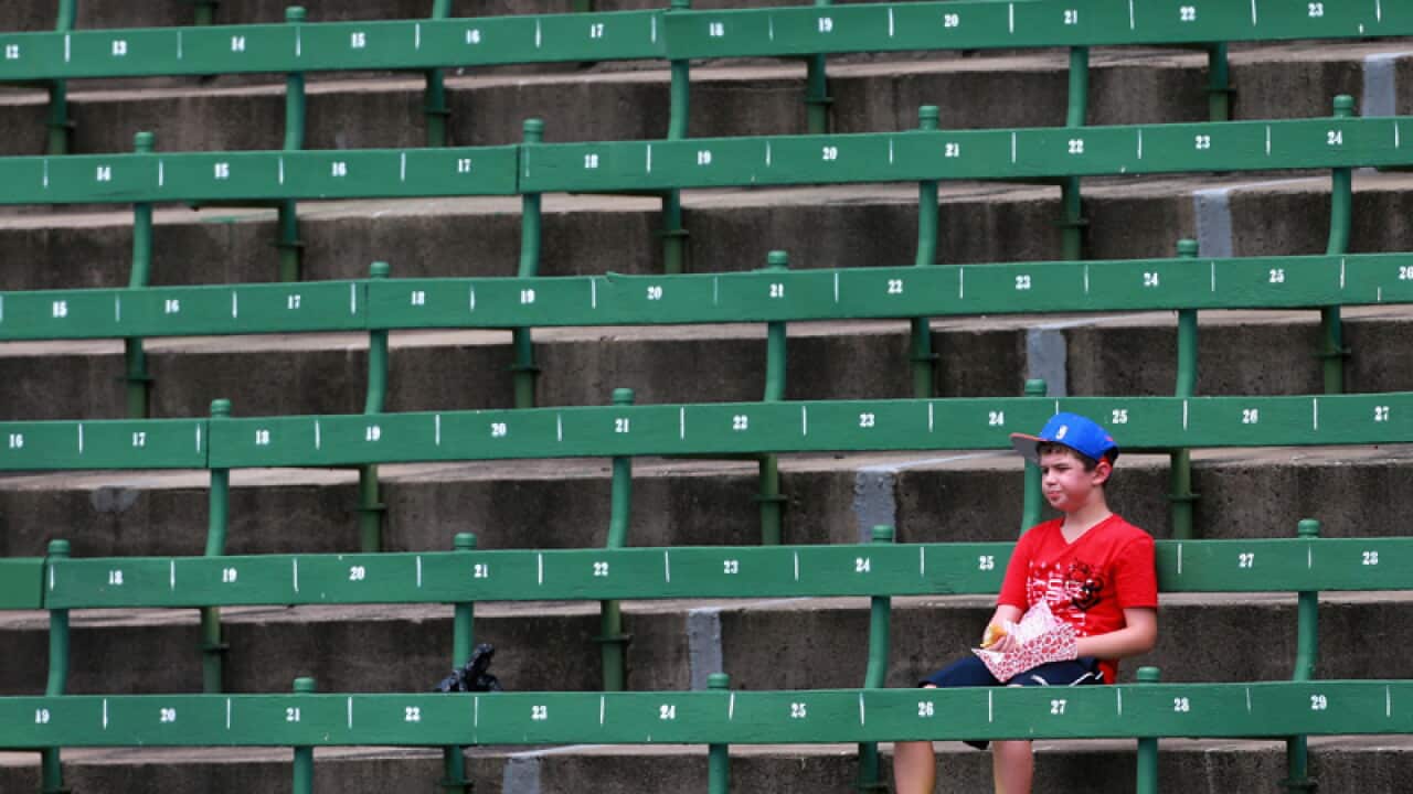 A fan watches on during the Kooyong Classic