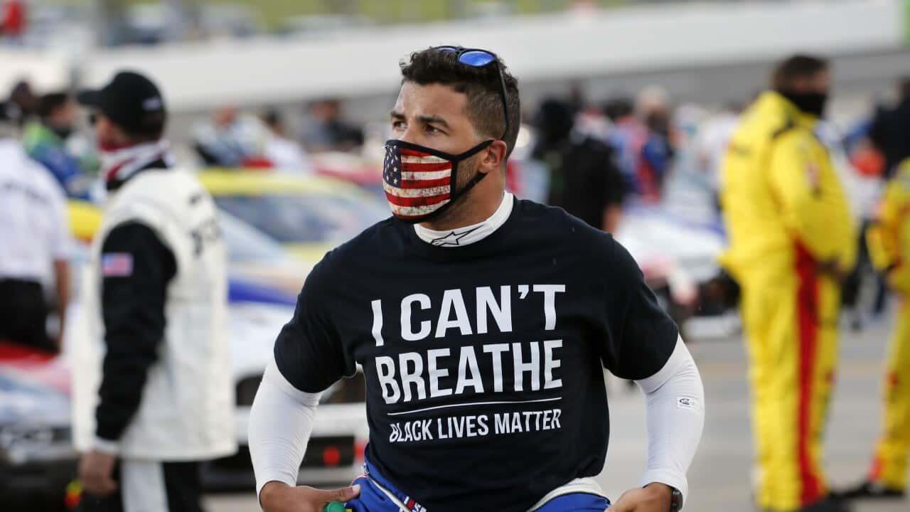 Driver Bubba Wallace wears a Black Lives Matter shirt as he prepares for a NASCAR Cup Series auto race Wednesday, June 10, 2020, in Martinsville, Va. (AP Photo/Steve Helber)