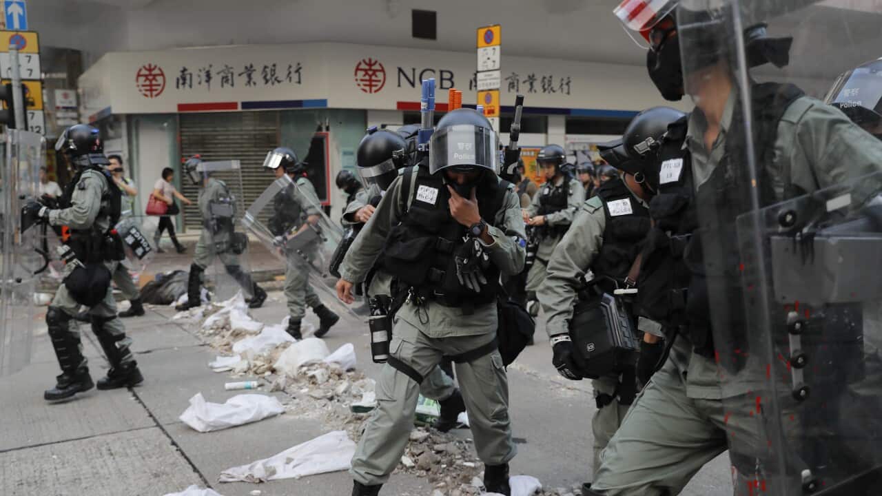Riot police cross barricade made by protesters during a protest in Hong Kong.