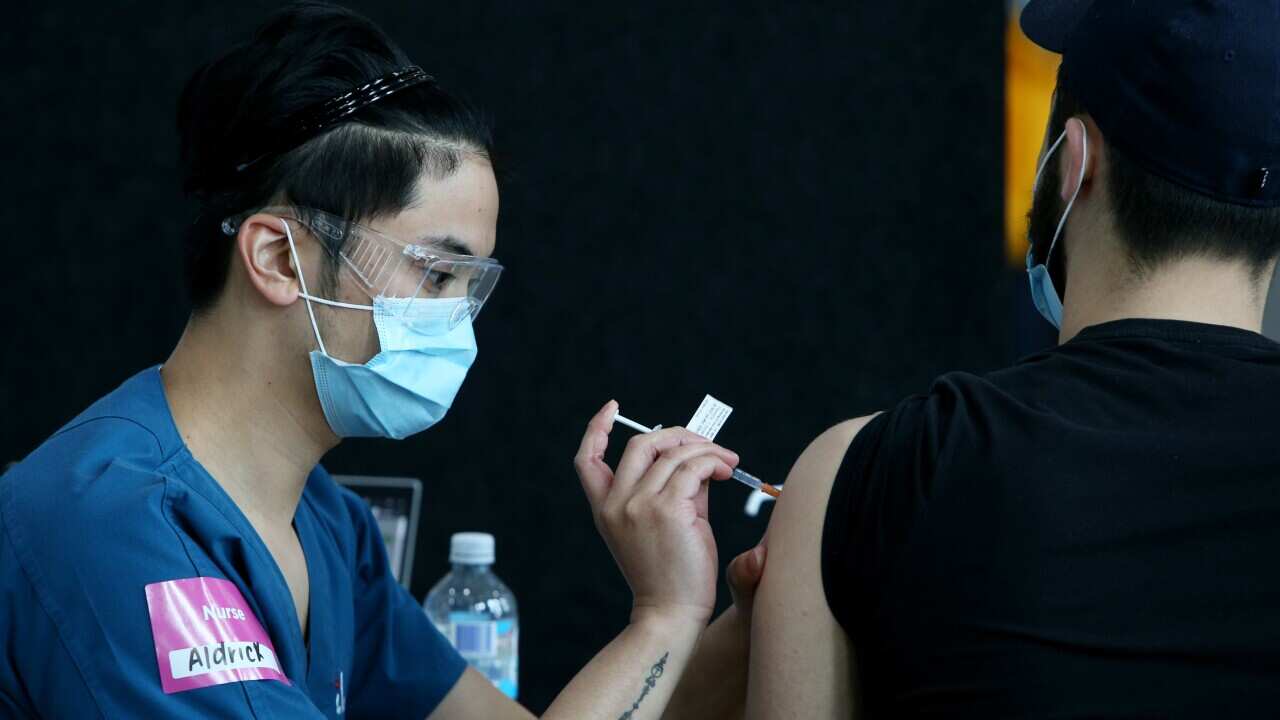 A registered nurse administers a COVID-19 vaccine to a client at the Lebanese Muslim Association in Lakemba on 8 August, 2021 in Sydney.