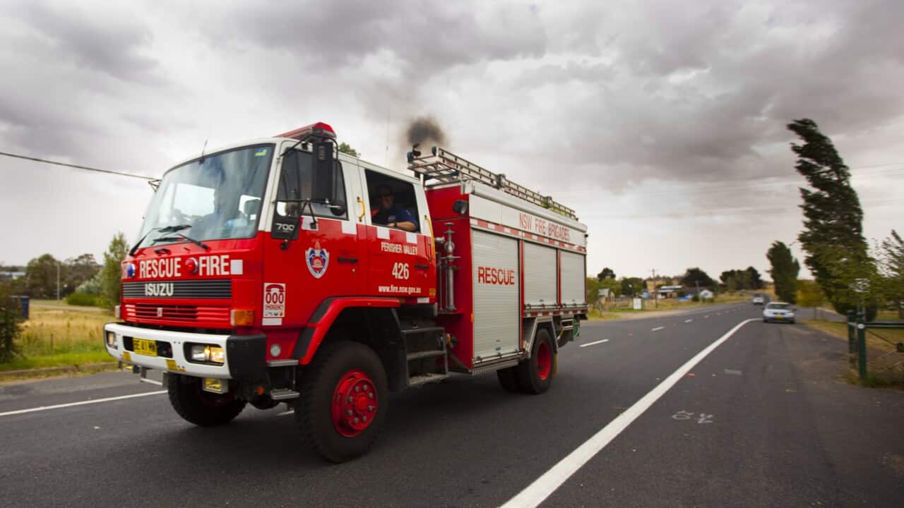 A fire rescue truck driving down a freeway.