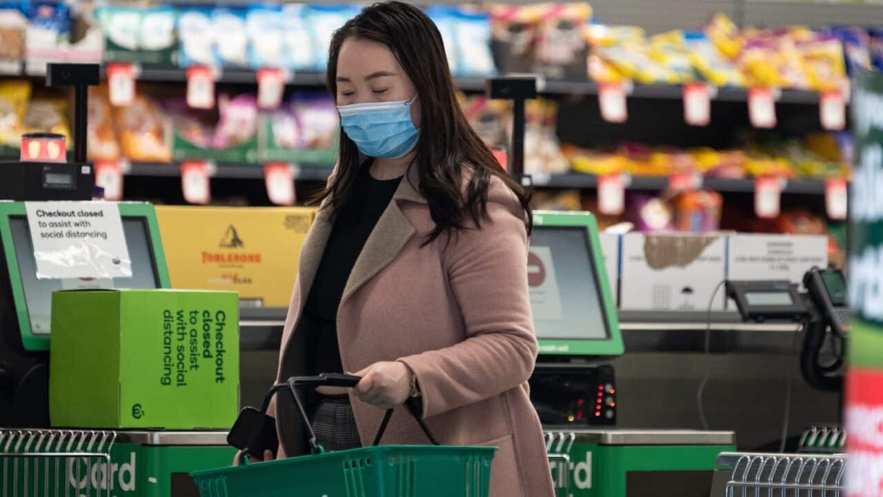 A shopper wearing a face mask inside a Woolworths shop.