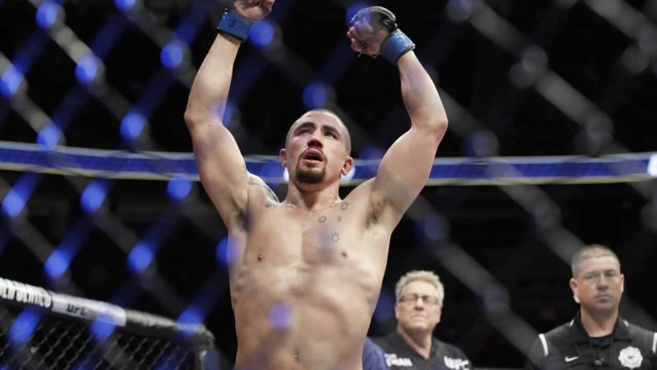 Robert Whittaker celebrates after defeating Yoel Romero