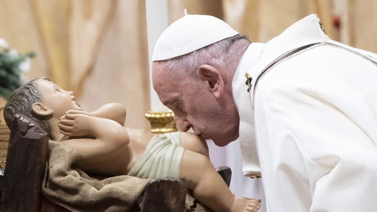 epaselect epa08089350 Pope Francis kisses Holy Jesus statue as he leads the Christmas Holy Mass in Saint Peter's Basilica at the Vatican, 24 December 2019. EPA/CLAUDIO PERI