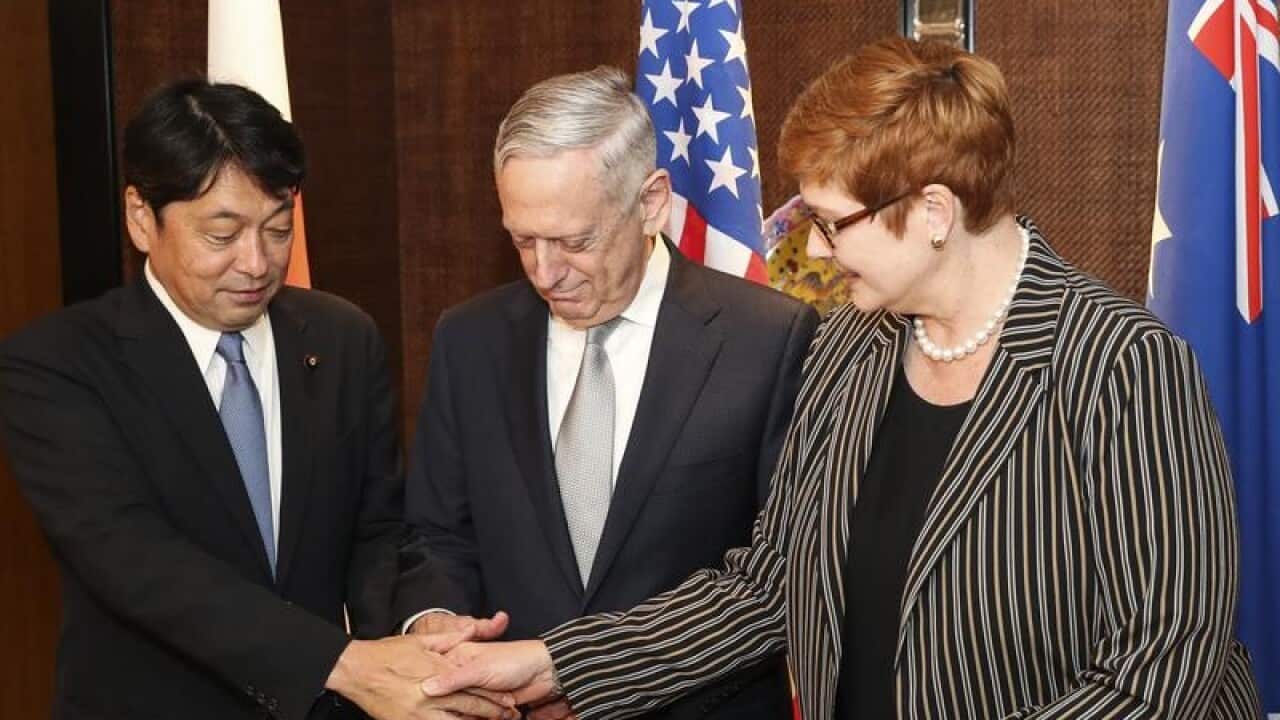 Japan's Itsunori Onodera, Jim Mattis and Marise Payne shake hands
