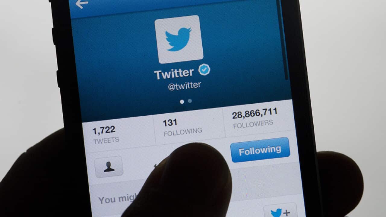 A person uses Twitter on a phone