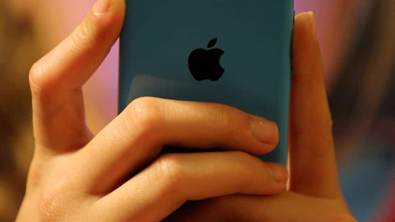 A teenager using social media on a mobile phone