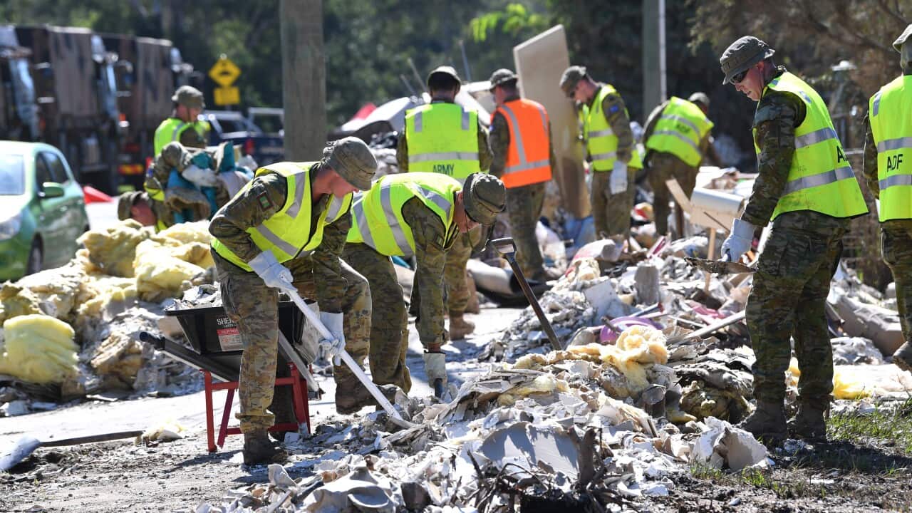 Members of the Australian Defence Force are seen helping in the clean up of flood-affected properties.