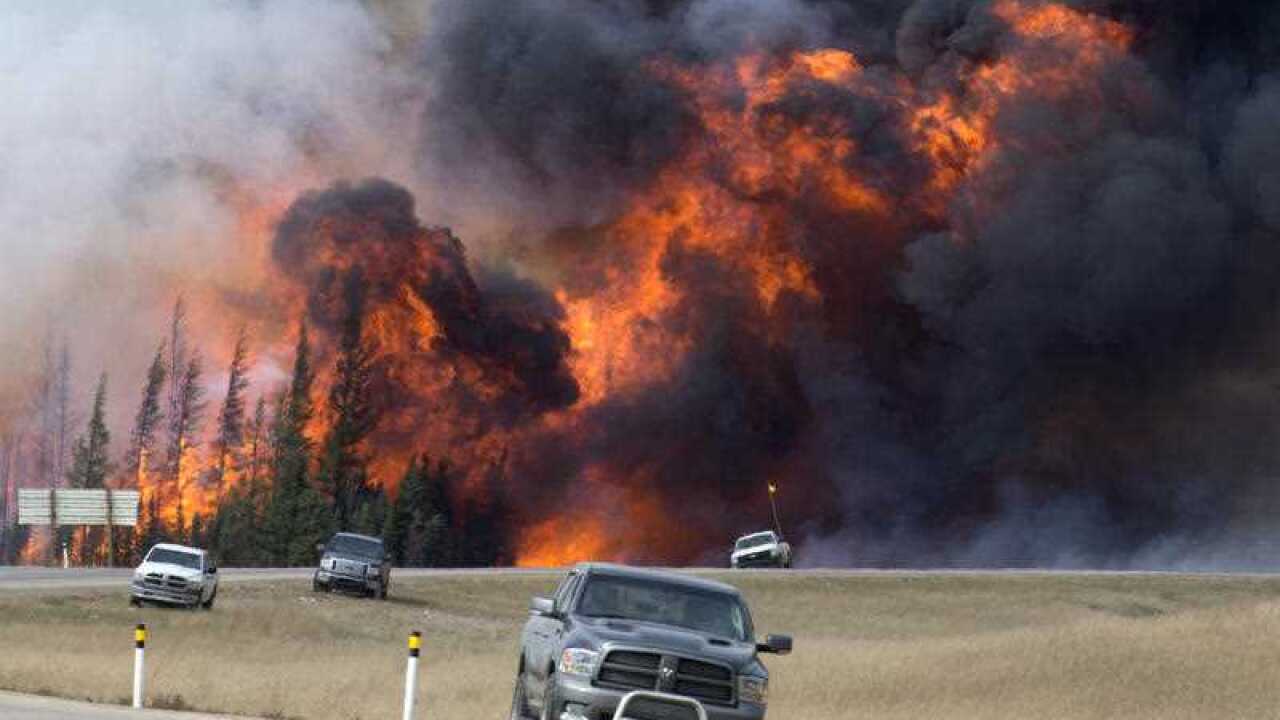 A wildfire burns south of Fort McMurray, Alberta, near Highway 63 on Saturday, May 7, 2016.