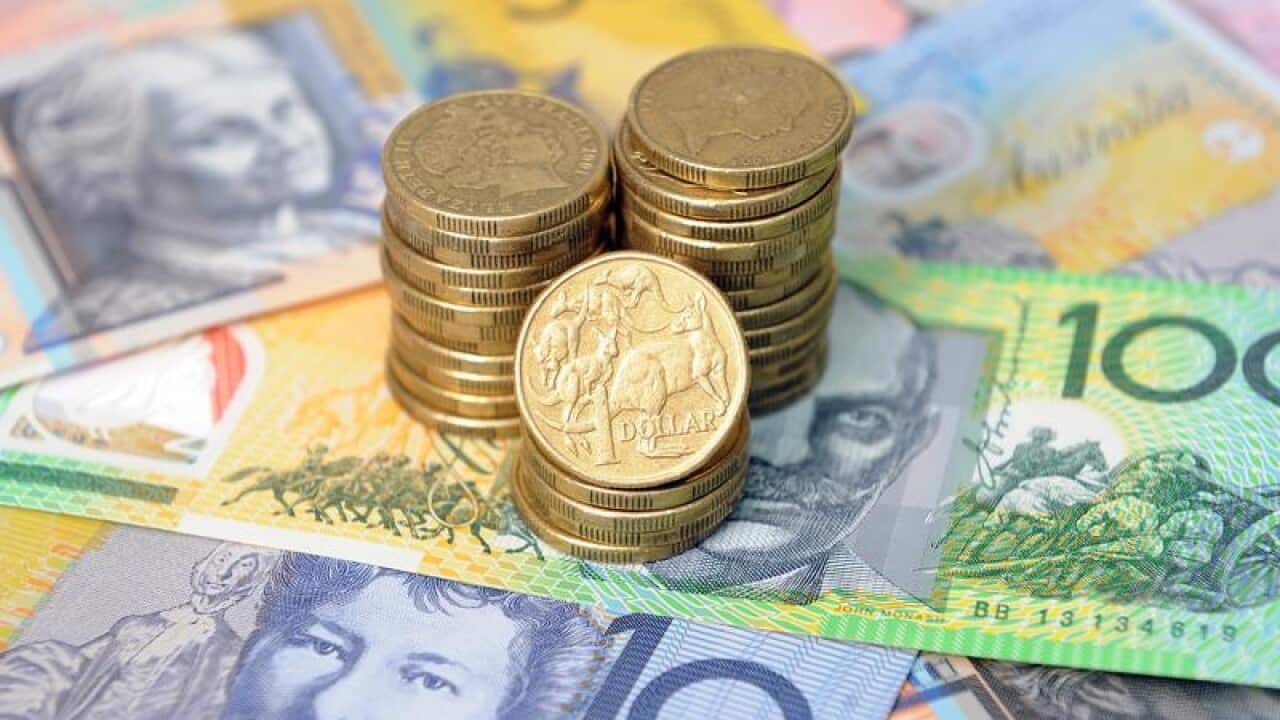Stock image of Australian dollars stacked on top of notes in Sydney.