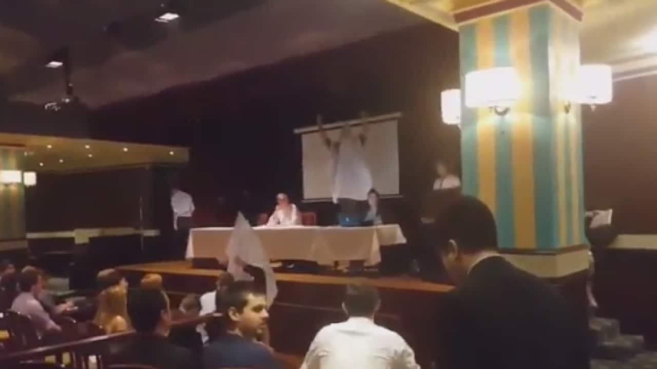 men dressed in white hoods