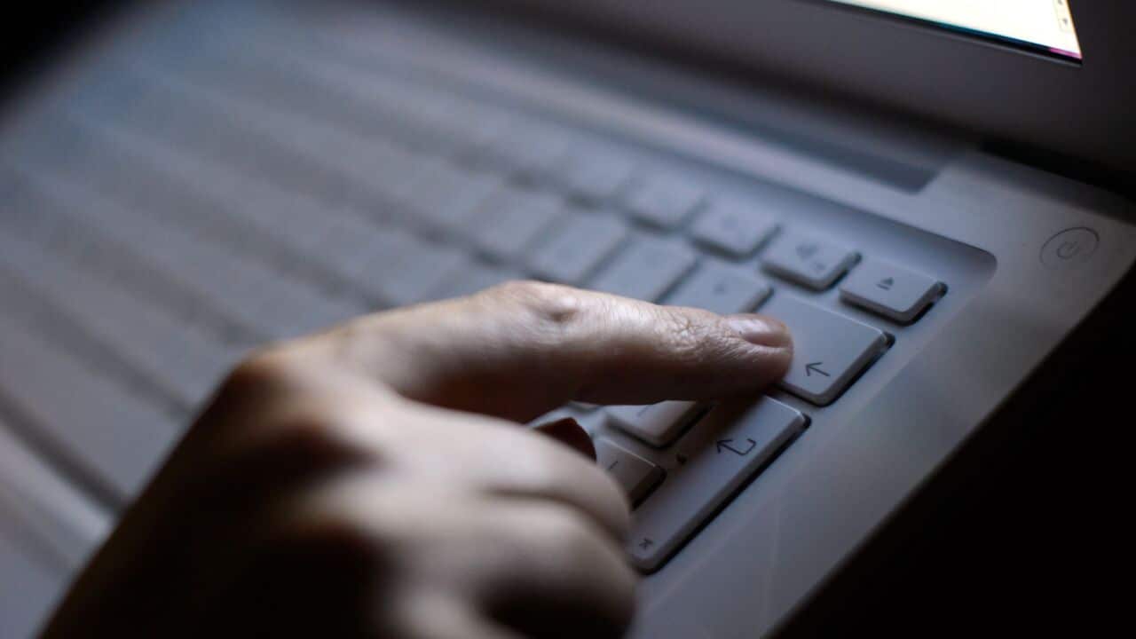 Someone typing on a computer