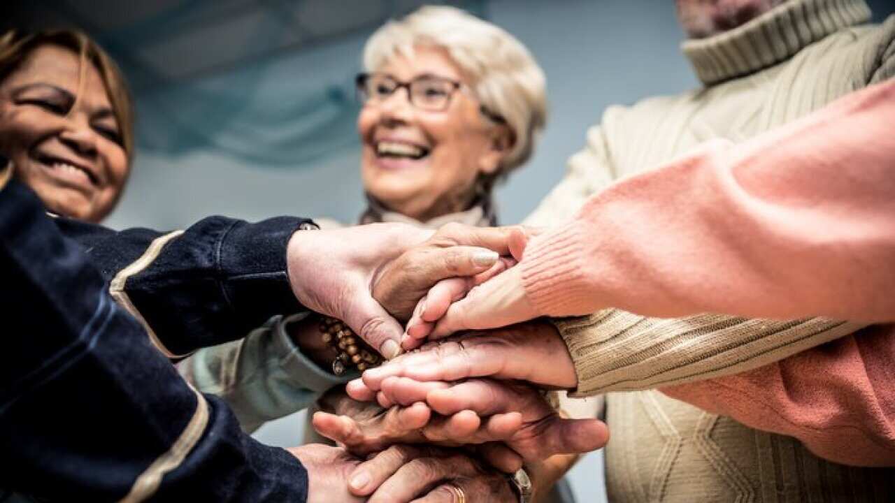 Group of seniors making activities inside the hospice