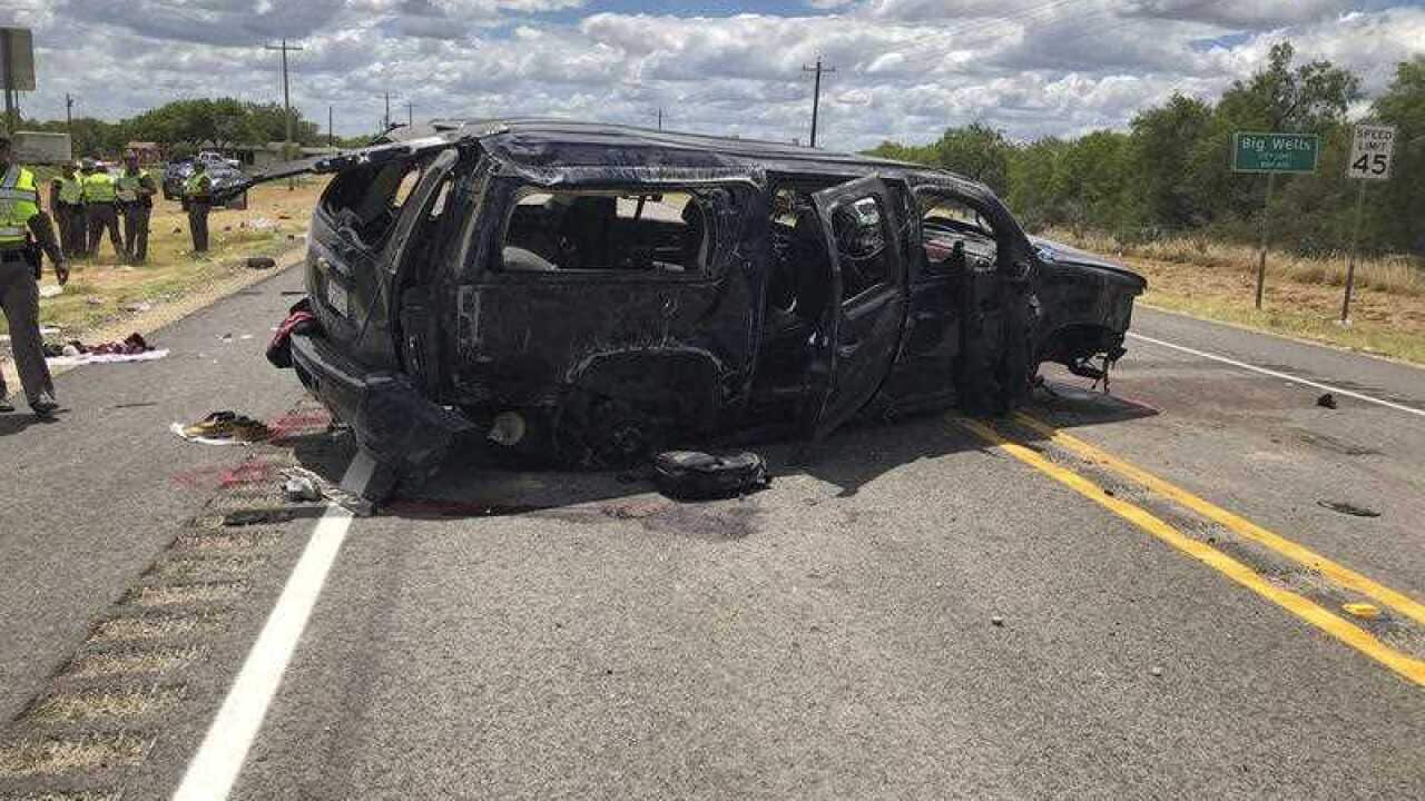 A heavily damaged SUV is seen on Texas Highway 85 in Big Wells, Texas, after crashing while carrying more than a dozen people fleeing from Border Patrol agents.
