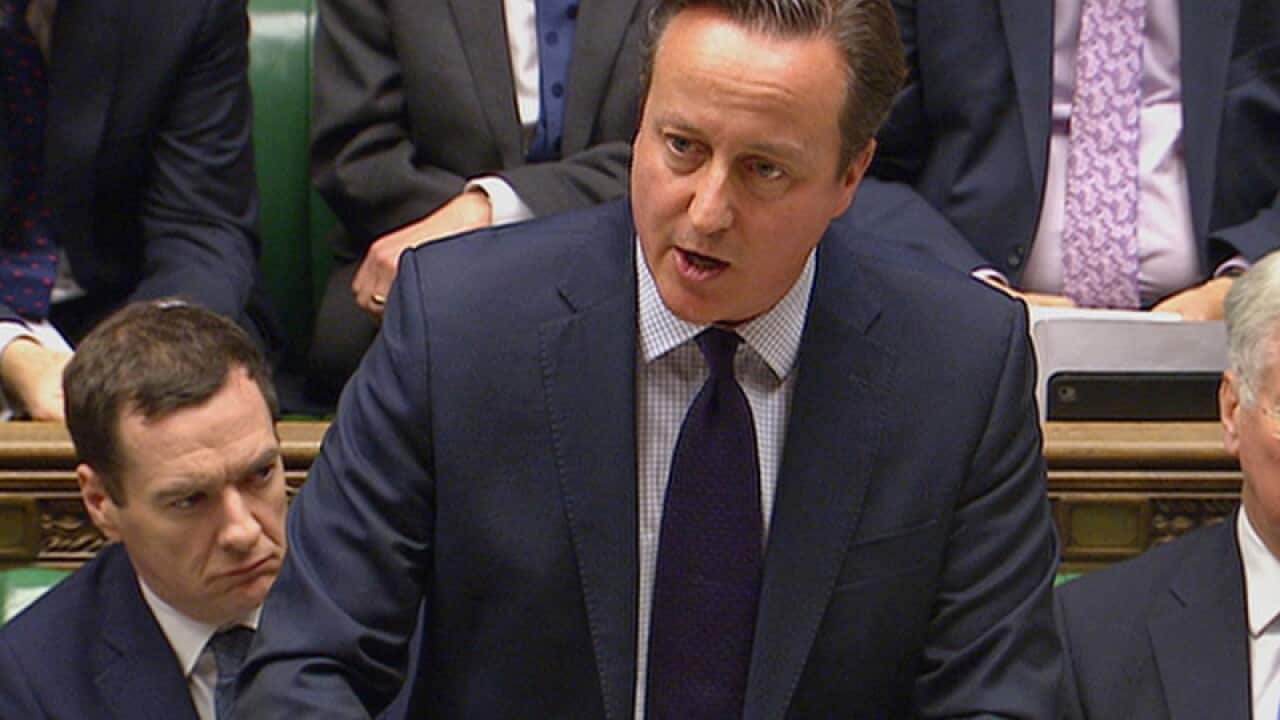 British Prime Minister David Cameron talks to lawmakers