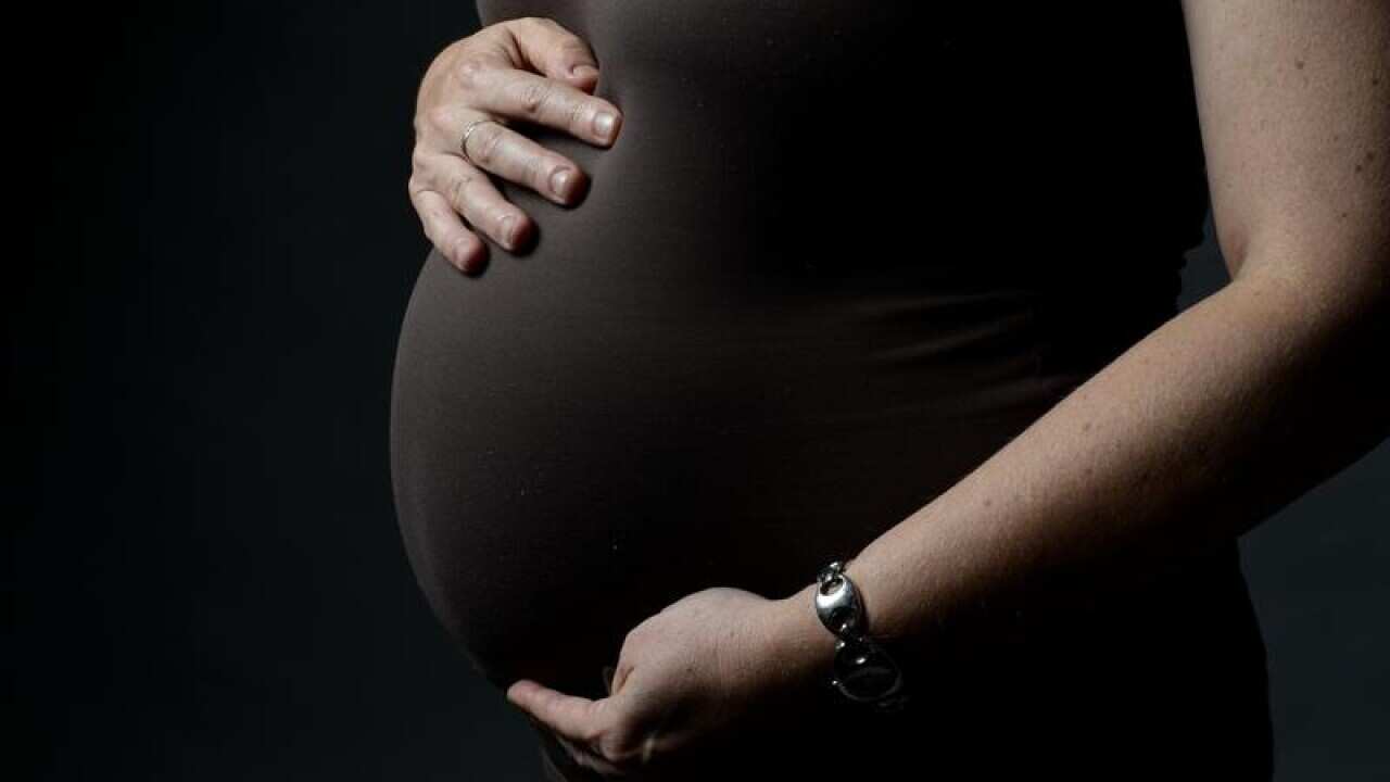 A pregnant woman.