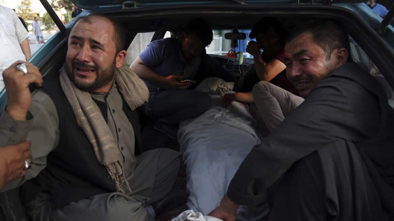 The body of a man killed in a deadly suicide bombing is taken for burial in western Kabul