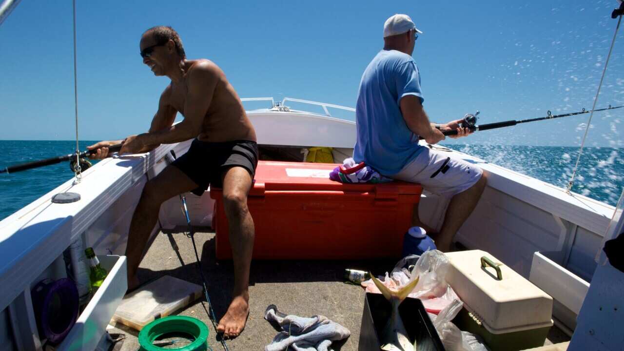 two men fishing in boat in Western Australia