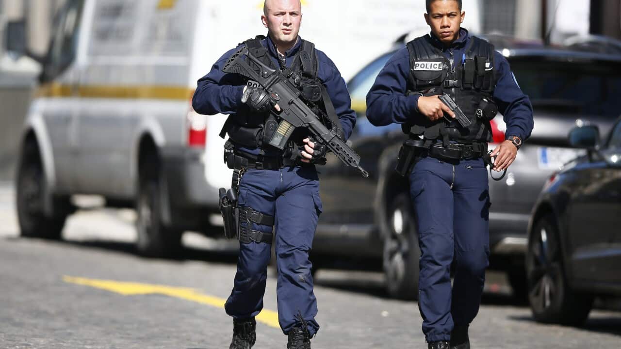 Police officers stand guard outside the International Monetary Fund (IMF) heqdquarters in Paris, France, 16 March 2017.