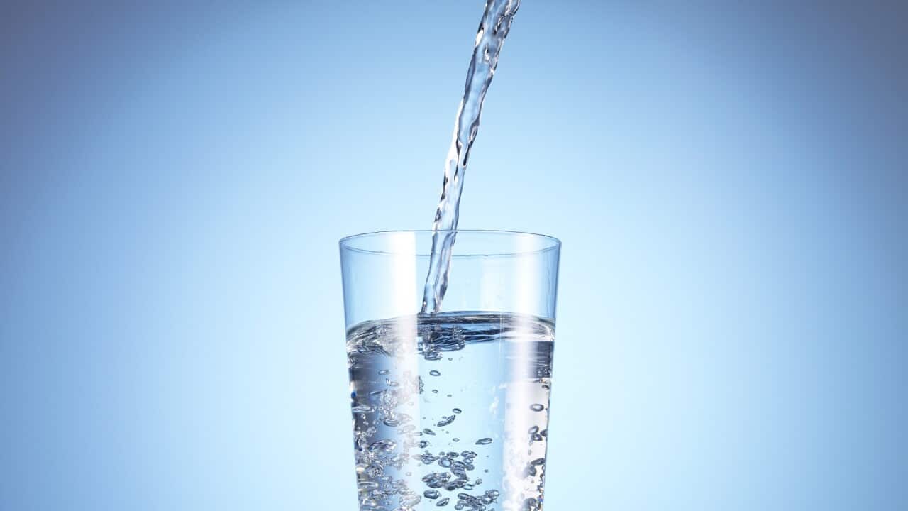 Cold drink water being poured into glass