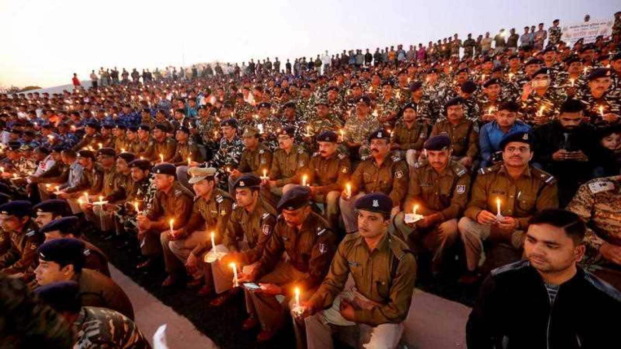 Central Reserve Police Force (CRPF) and Rapid Action Force (RAF) soldiers and their family members hold candles.