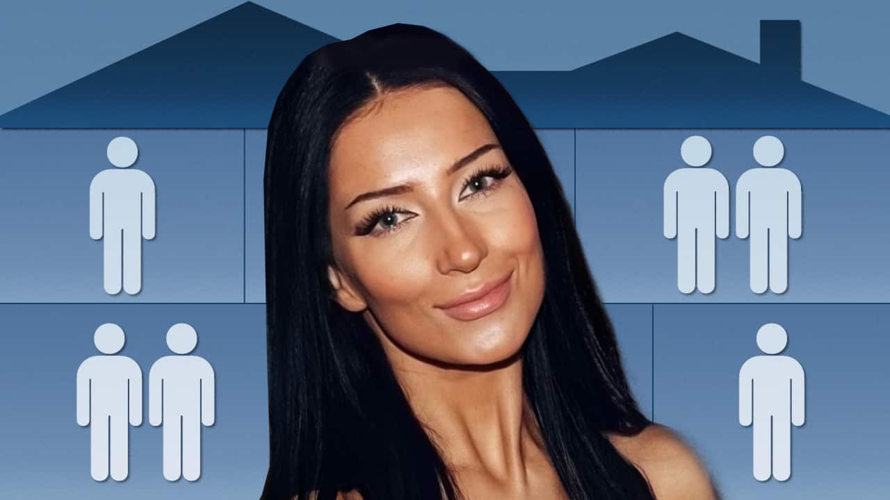 a close up of a young woman with black hair and the background is a blue house with multiple rooms and stick figures