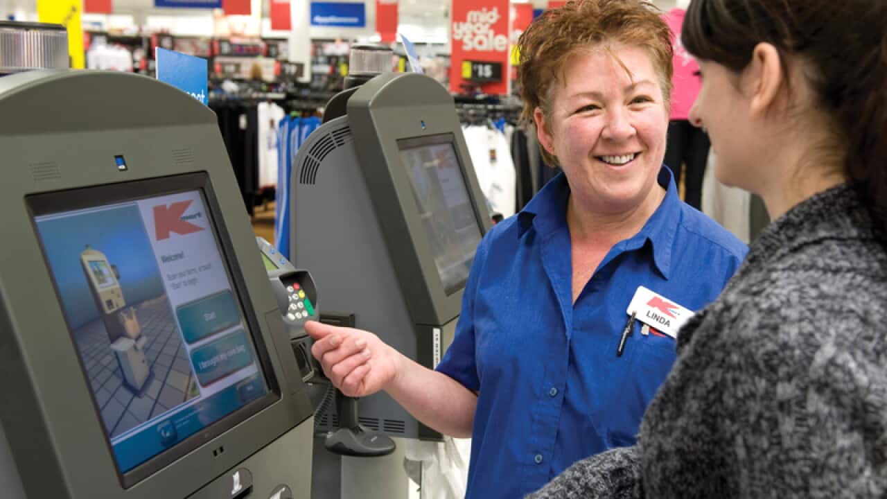 A K-Mart employee assisting a customer