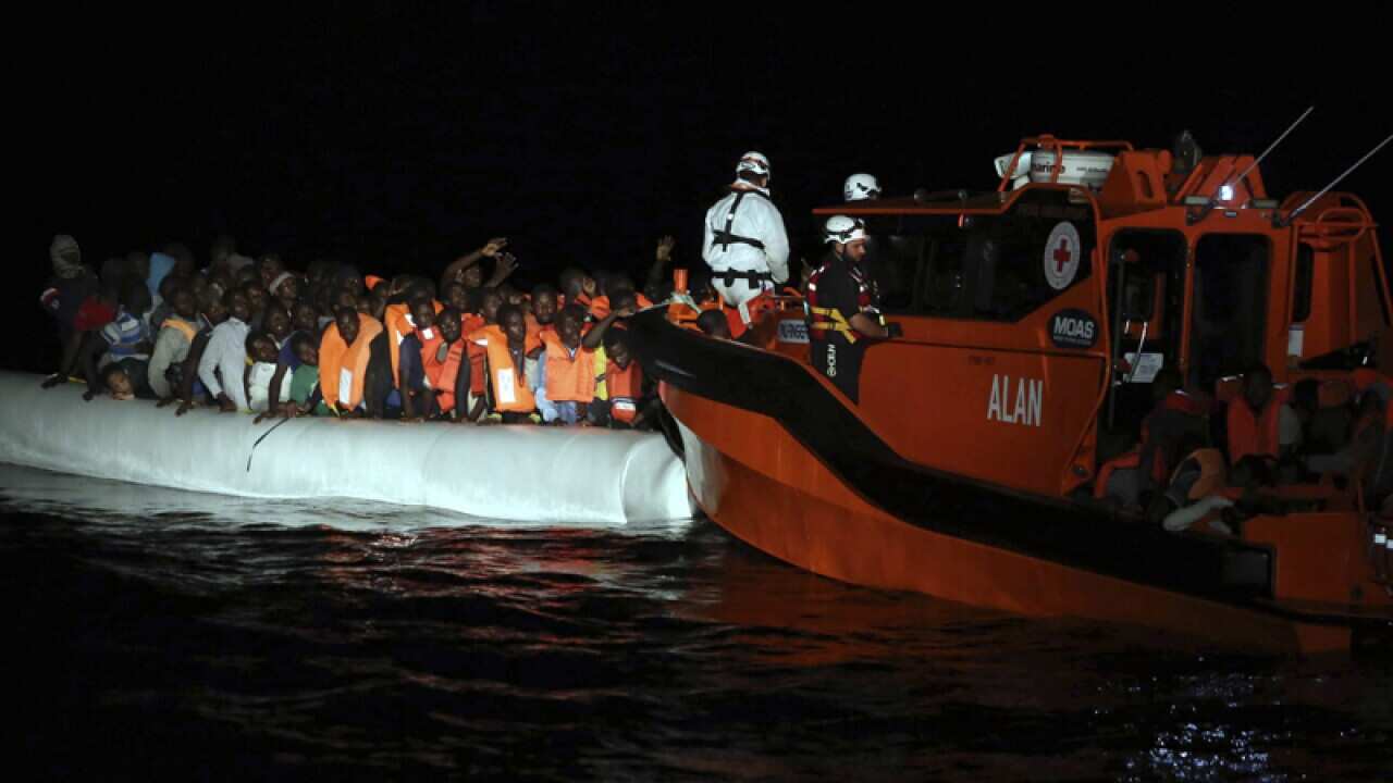 Migrants on dinghy boats are rescued in the Mediterranean Sea