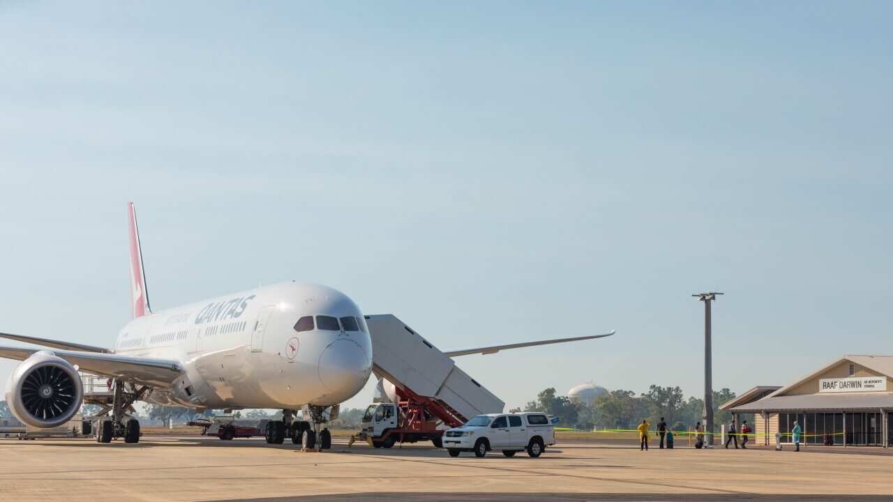 Passengers disembark a Qantas repatriation flight from India at RAAF Base Darwin.