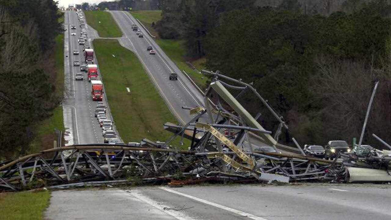 A fallen cell tower lies across U.S. Route 280 highway