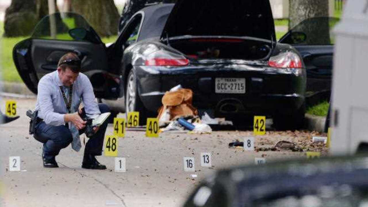Police investigate the suspect's car in Monday, Sept. 26, 2016, after a shooting in Houston.