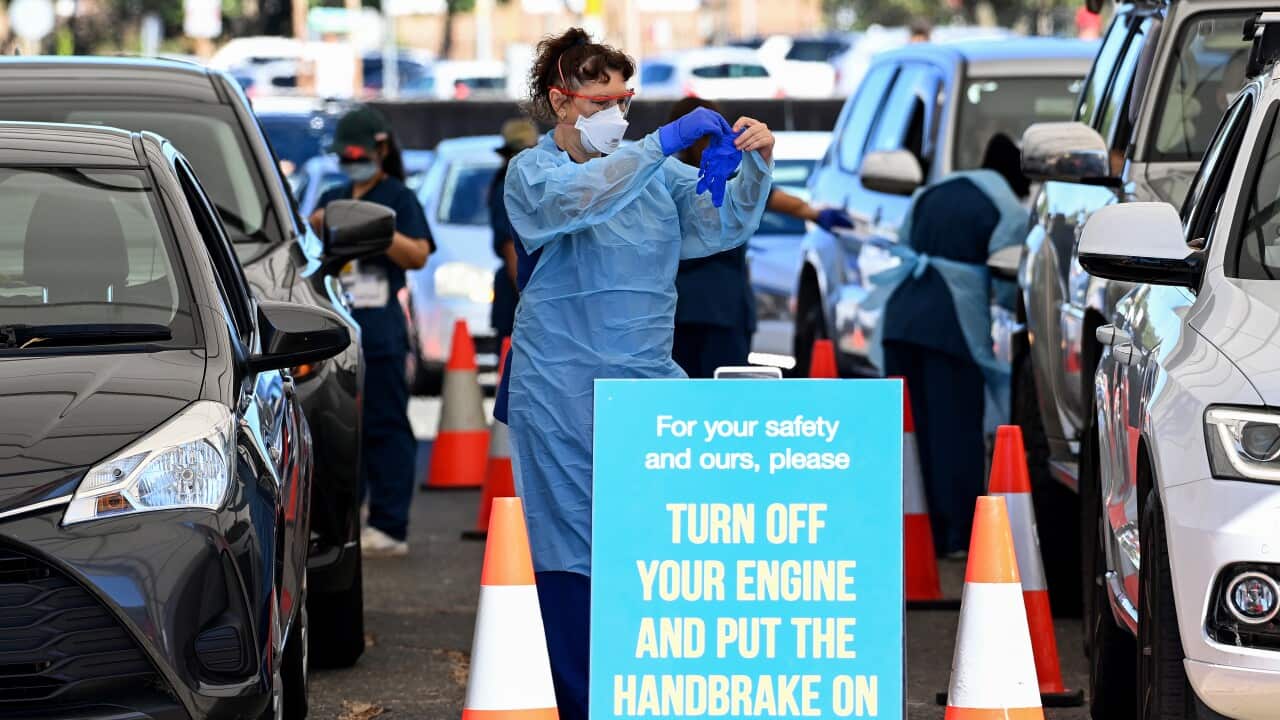 Health care workers administer COVID-19 PCR tests at the St Vincents Drive-through Clinic at Bondi Beach in Sydney, Friday, December 31, 2021.