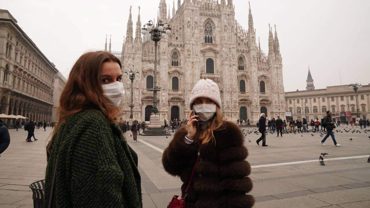Tourists wearing mask at Milan's Piazza Duomo.