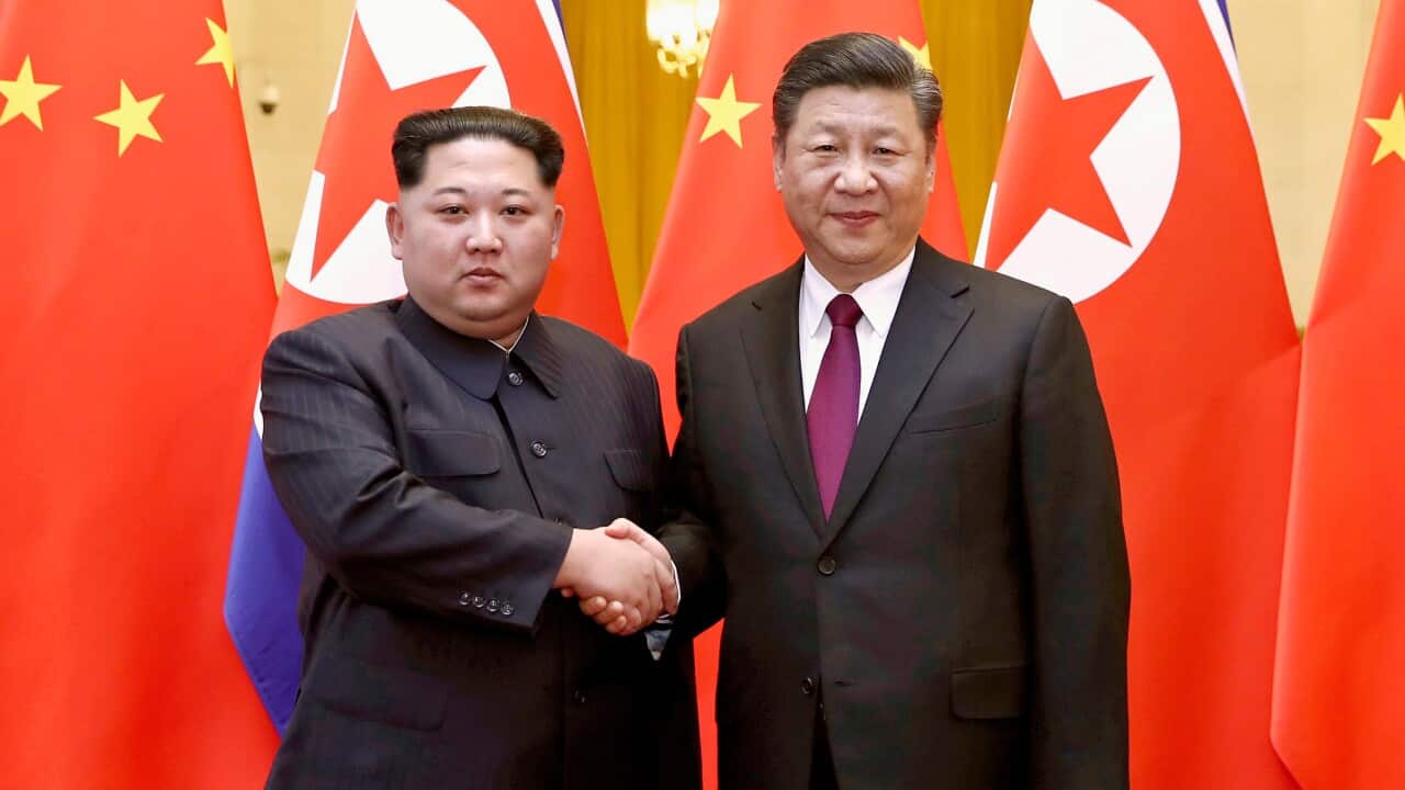 North Korean leader Kim Jong Un, left, and Chinese President Xi Jinping poses for a photo in Beijing.