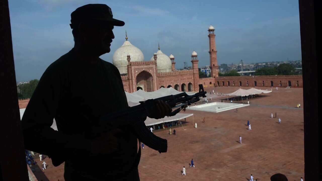 Security guards the route as Muslims gather to pray during Eid al-Adha at the historical Badshahi Mosque in Lahore, Pakistan on September 02, 2017