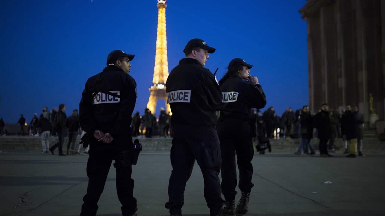 French police officers patrol at Trocadero plaza near the Eiffel Tower in Paris.