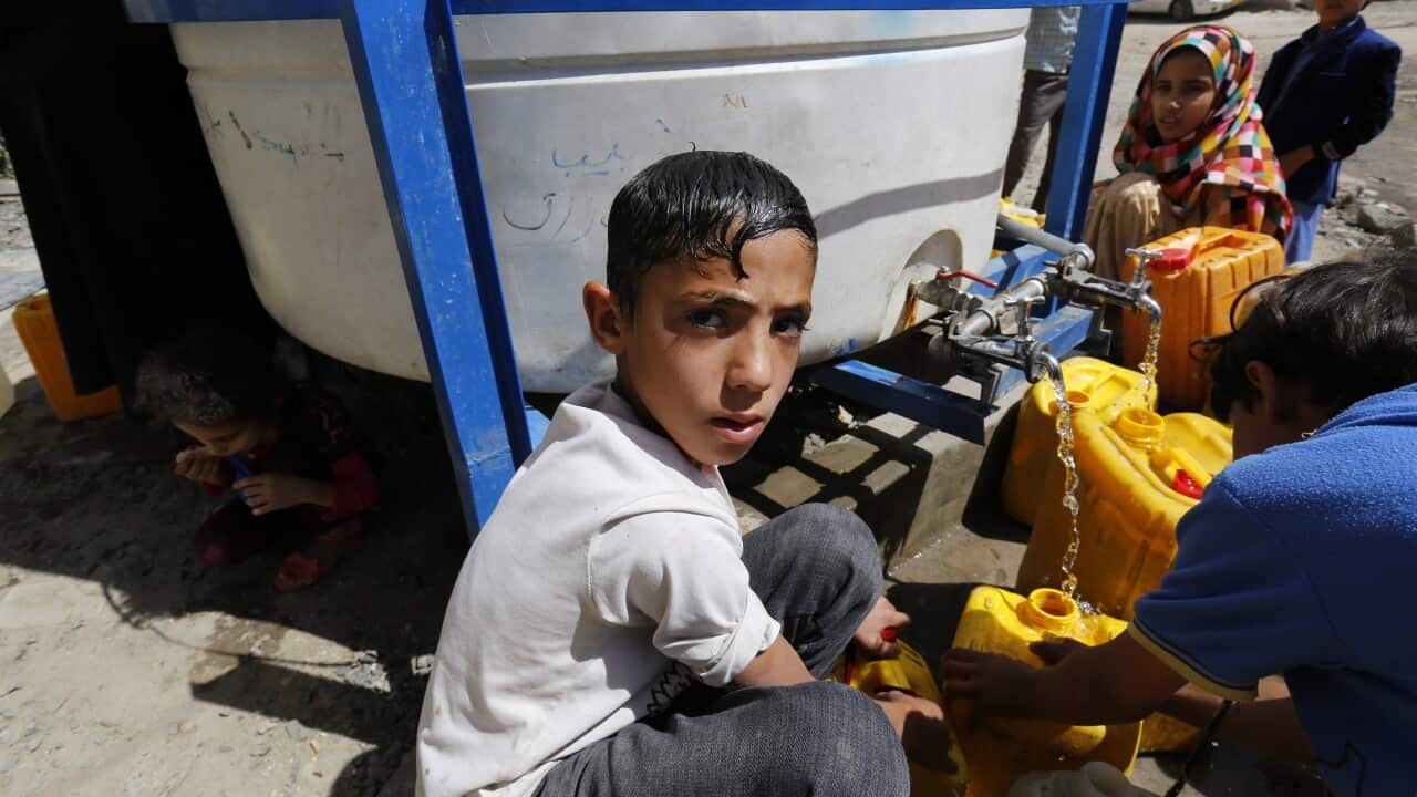 Yemenis fill jerrycans with safe drinking water from a donated water pipe in Sana'a, Yemen, 20 May 2017.