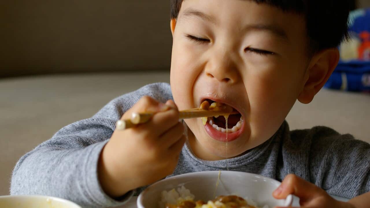 Boy eating natto